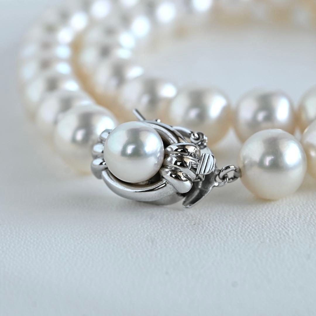 Hanadama Akoya pearl necklace with round 8-8.5mm pearls and silver fastener on a white background