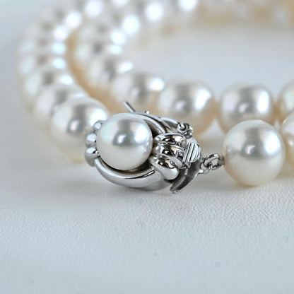 Hanadama Akoya pearl necklace with round 8-8.5mm pearls and silver fastener on a white background