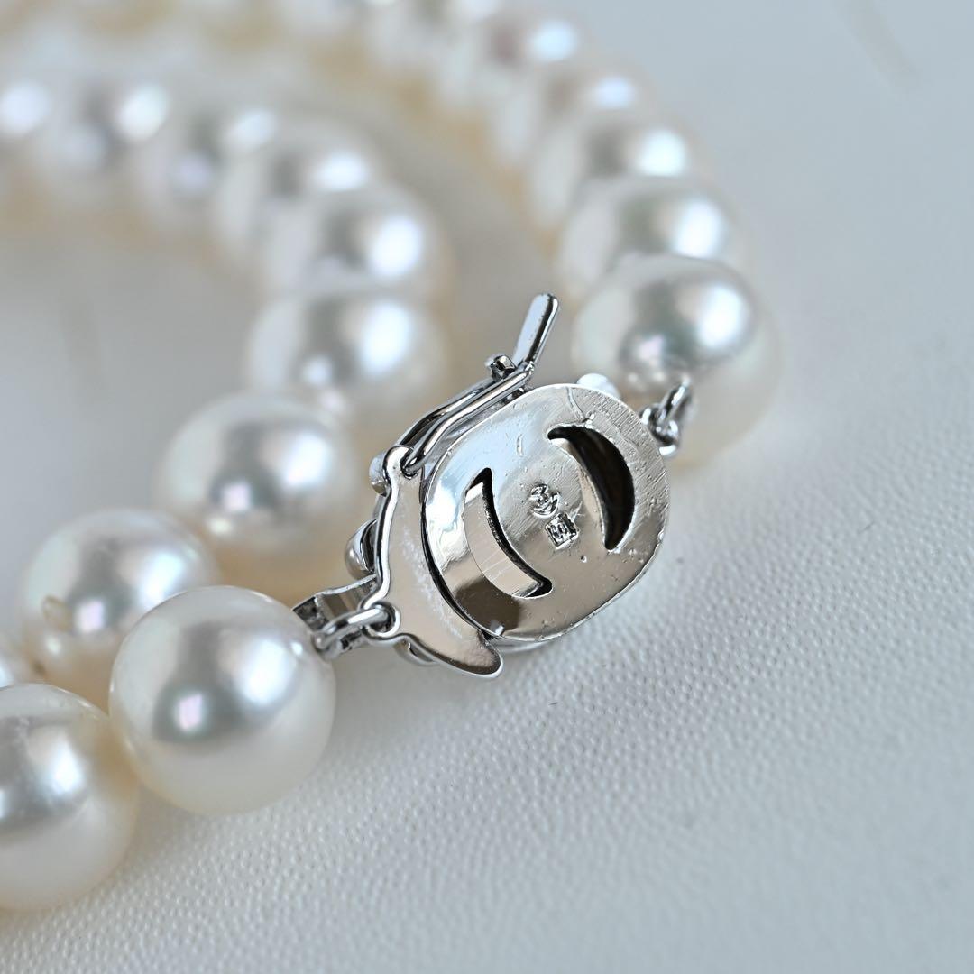 Hanadama Akoya pearl necklace with round 8-8.5mm pearls and silver fastener on a white background