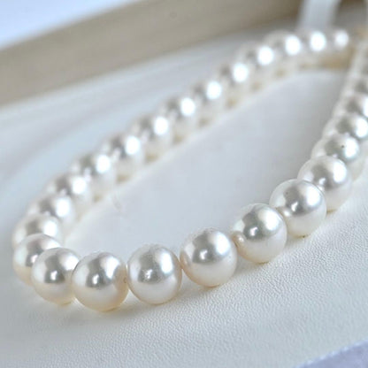 Hanadama Akoya pearl necklace with round 8-8.5mm pearls and silver fastener on a white background