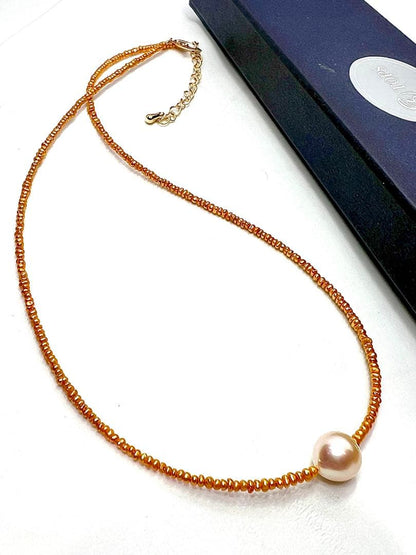 Gold Akoya pearl necklace featuring 8.5mm gold pearls and 2mm gold Kesh baby pearls on adjustable chain