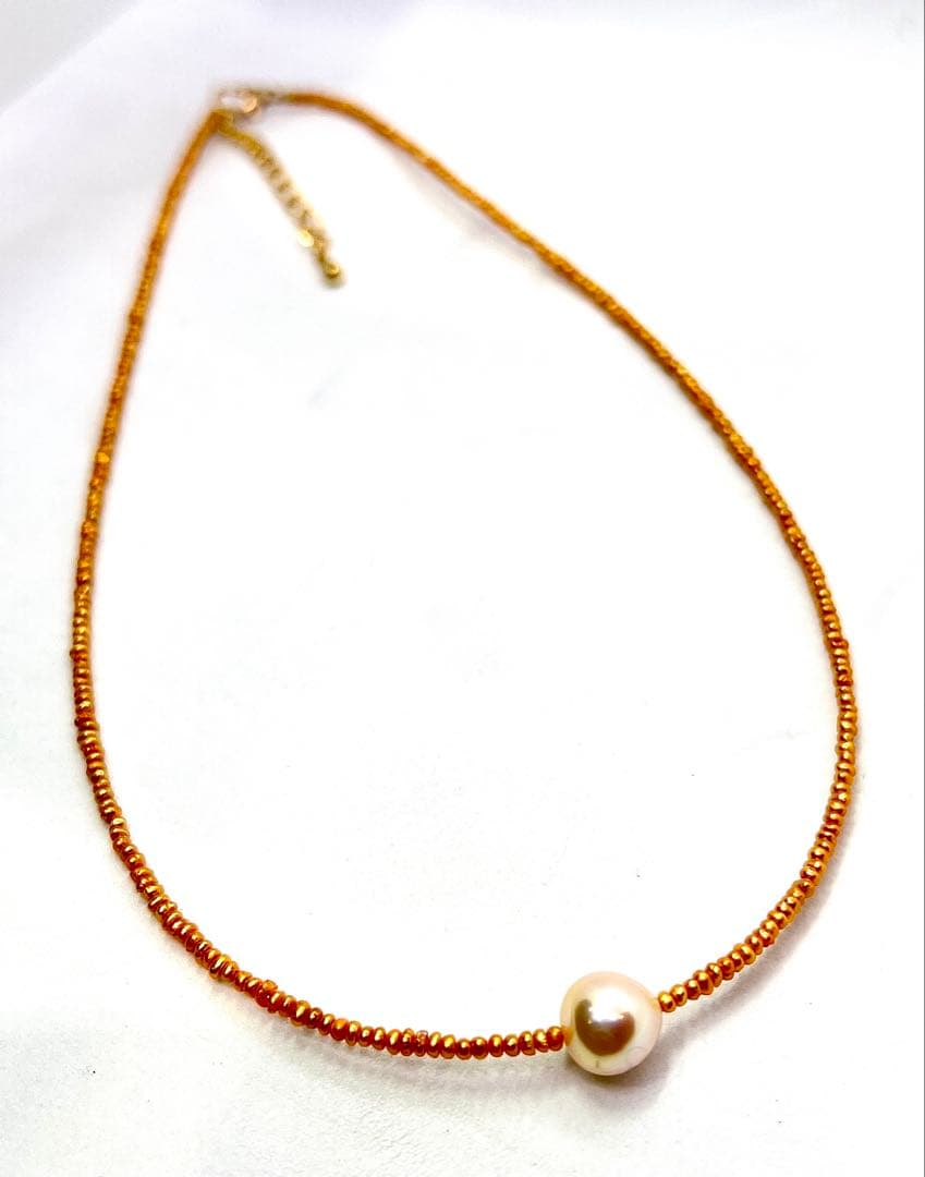 Gold Akoya pearl necklace featuring 8.5mm gold pearls and 2mm gold Kesh baby pearls on adjustable chain