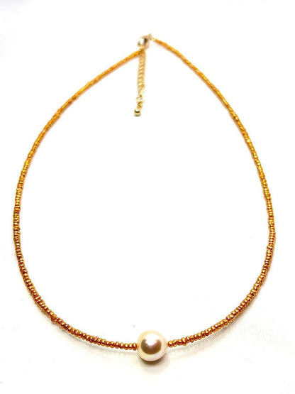 Gold Akoya pearl necklace featuring 8.5mm gold pearls and 2mm gold Kesh baby pearls on adjustable chain