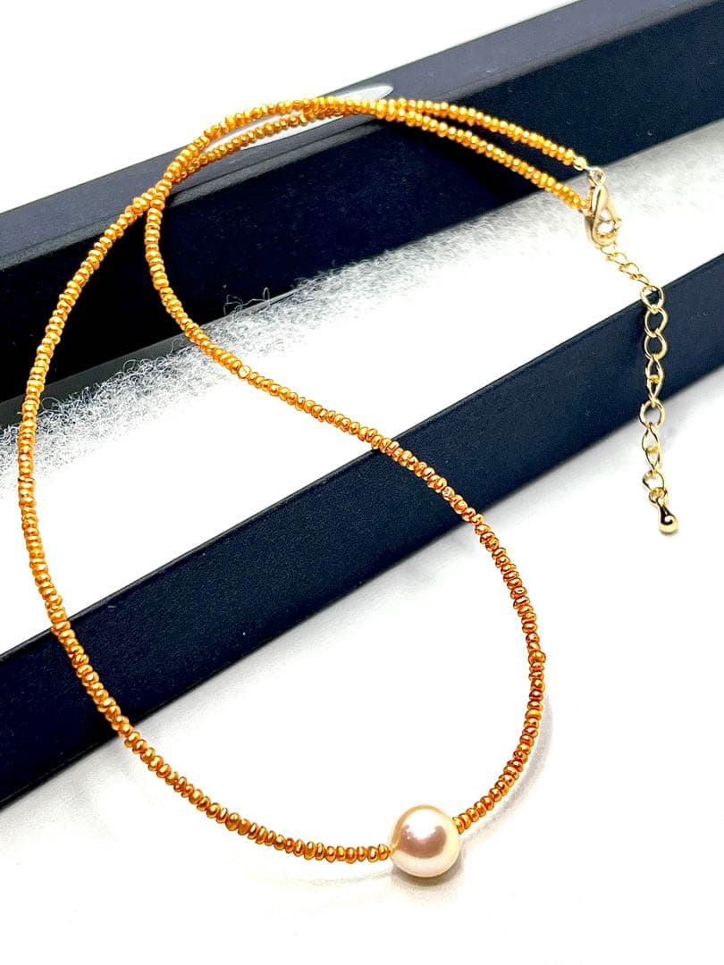 Gold Akoya pearl necklace featuring 8.5mm gold pearls and 2mm gold Kesh baby pearls on adjustable chain