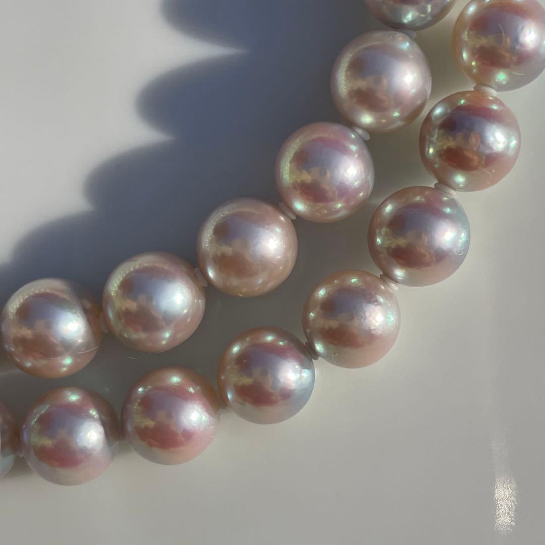 Akoya pearl necklace with 7.5-8mm blue tone pearls and silver clasp displayed with certification and box