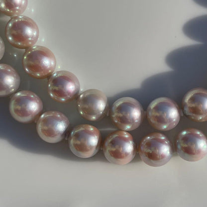 Akoya pearl necklace with 7.5-8mm blue tone pearls and silver clasp displayed with certification and box