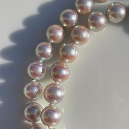 Akoya pearl necklace with 7.5-8mm blue tone pearls and silver clasp displayed with certification and box