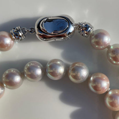 Akoya pearl necklace with 7.5-8mm blue tone pearls and silver clasp displayed with certification and box