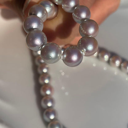 Akoya pearl necklace with 7.5-8mm blue tone pearls and silver clasp displayed with certification and box