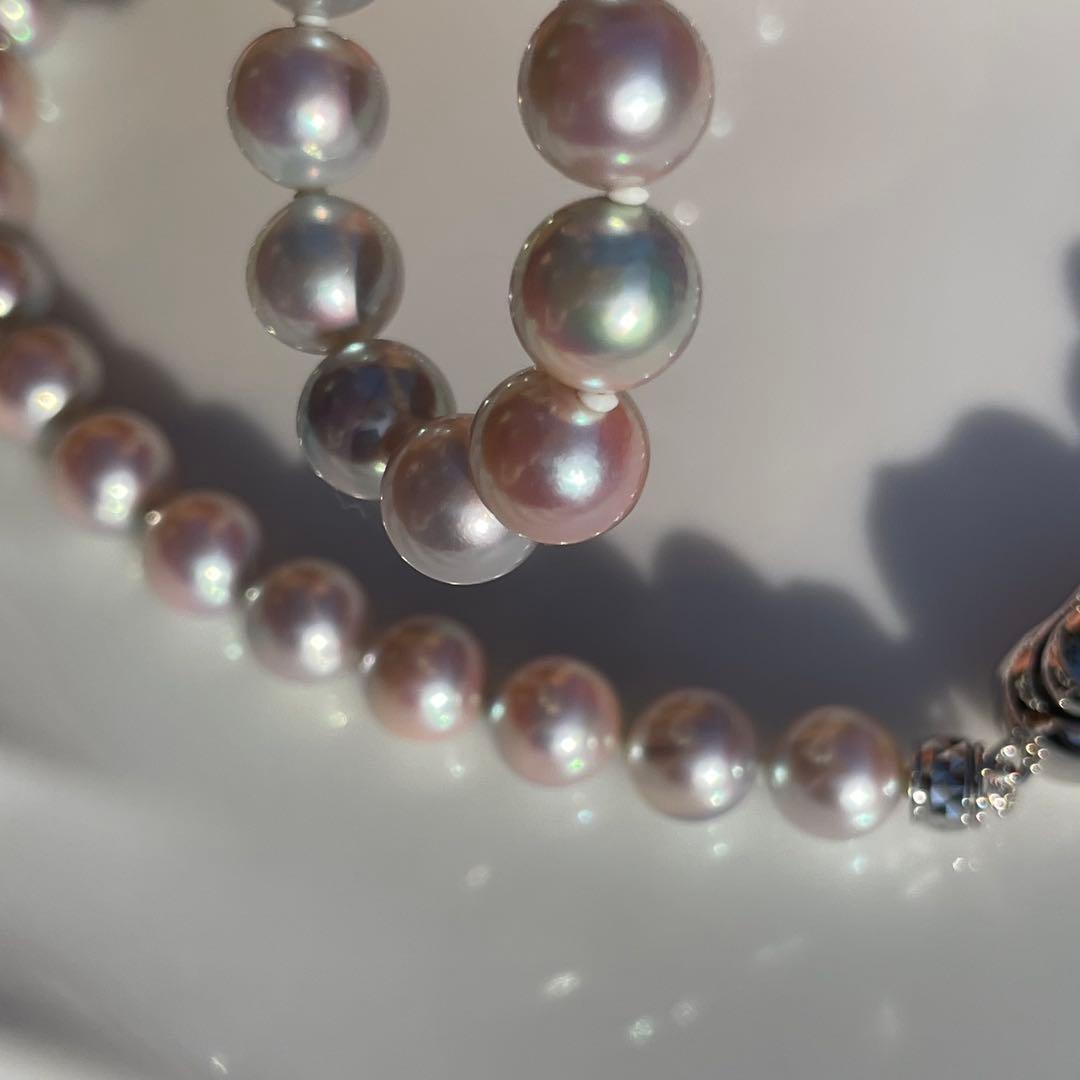 Akoya pearl necklace with 7.5-8mm blue tone pearls and silver clasp displayed with certification and box