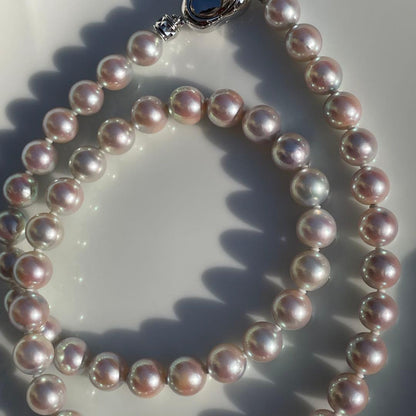 Akoya pearl necklace with 7.5-8mm blue tone pearls and silver clasp displayed with certification and box