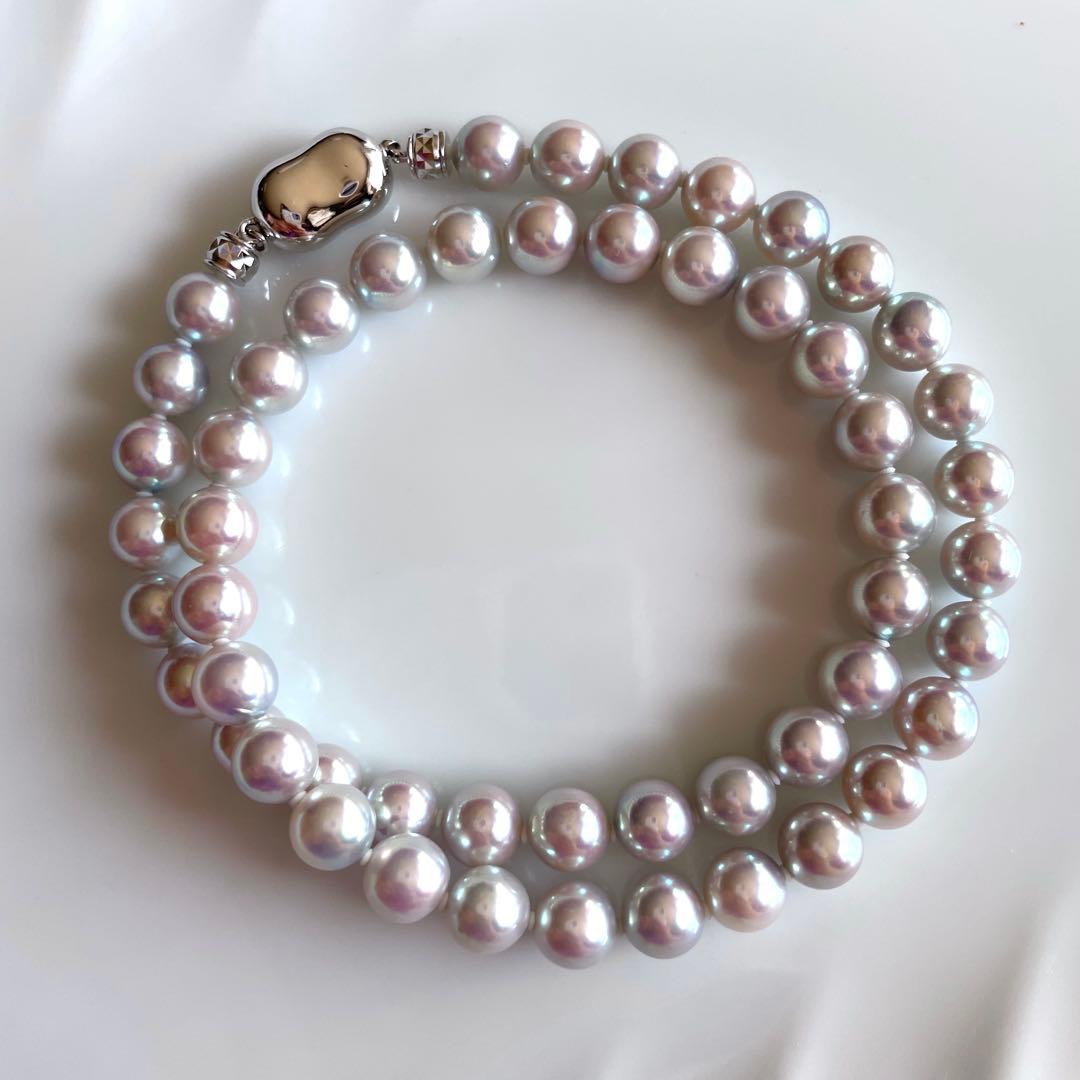 Akoya pearl necklace with 7.5-8mm blue tone pearls and silver clasp displayed with certification and box