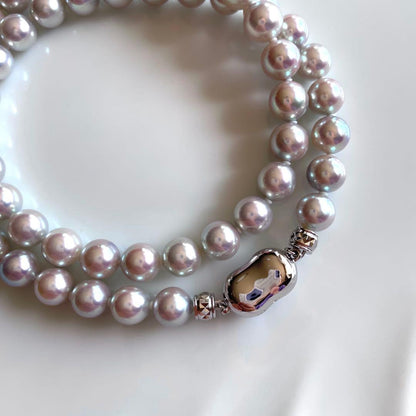 Akoya pearl necklace with 7.5-8mm blue tone pearls and silver clasp displayed with certification and box