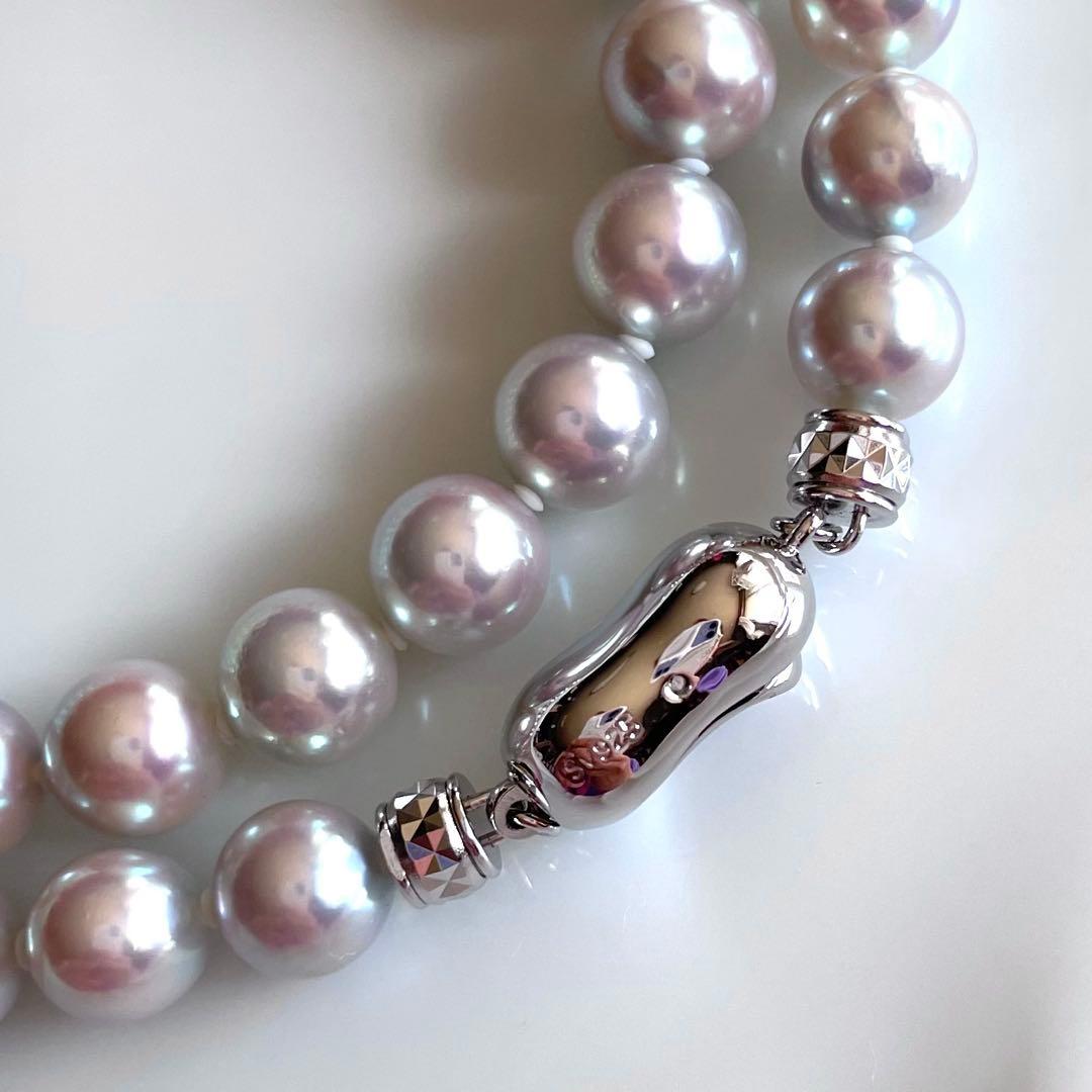Akoya pearl necklace with 7.5-8mm blue tone pearls and silver clasp displayed with certification and box