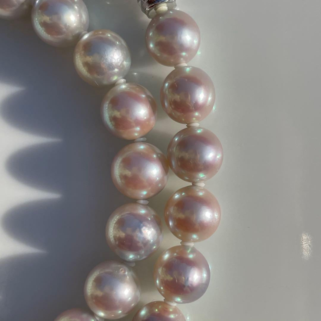 Akoya pearl necklace with 7.5-8mm blue tone pearls and silver clasp displayed with certification and box