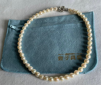 Natural 8mm Akoya pearl necklace with baroque pearls and silver clasp on a white background