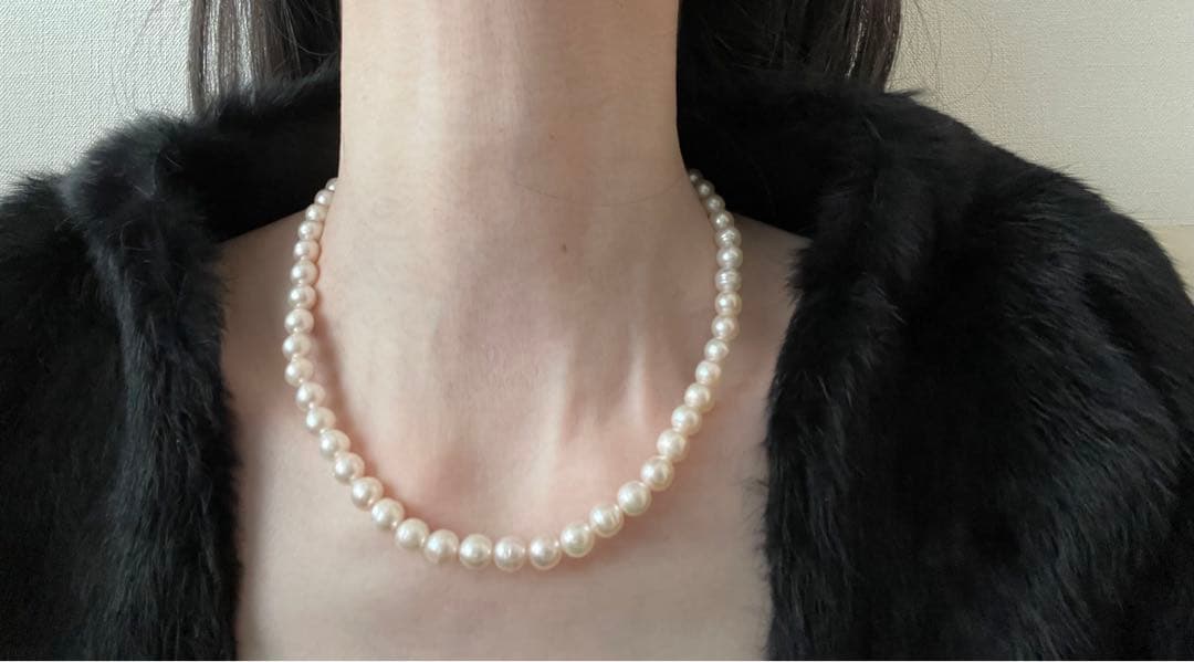 Natural 8mm Akoya pearl necklace with baroque pearls and silver clasp on a white background