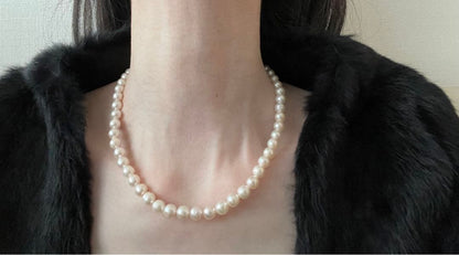 Natural 8mm Akoya pearl necklace with baroque pearls and silver clasp on a white background