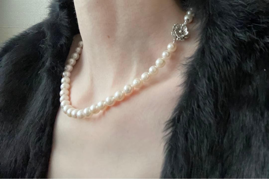Natural 8mm Akoya pearl necklace with baroque pearls and silver clasp on a white background