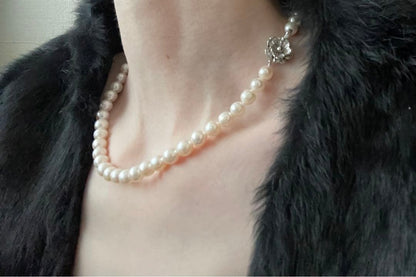 Natural 8mm Akoya pearl necklace with baroque pearls and silver clasp on a white background