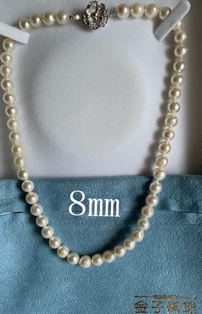 Natural 8mm Akoya pearl necklace with baroque pearls and silver clasp on a white background