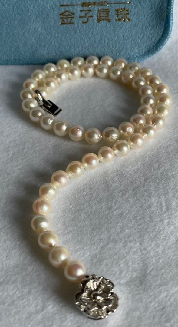Natural 8mm Akoya pearl necklace with baroque pearls and silver clasp on a white background