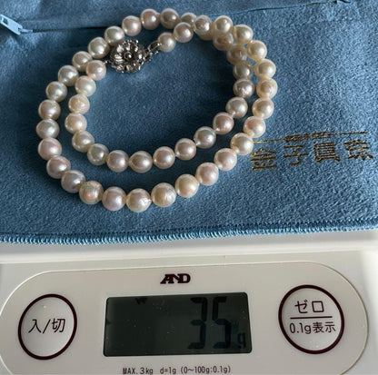 Natural 8mm Akoya pearl necklace with baroque pearls and silver clasp on a white background
