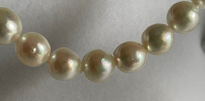 Natural 8mm Akoya pearl necklace with baroque pearls and silver clasp on a white background