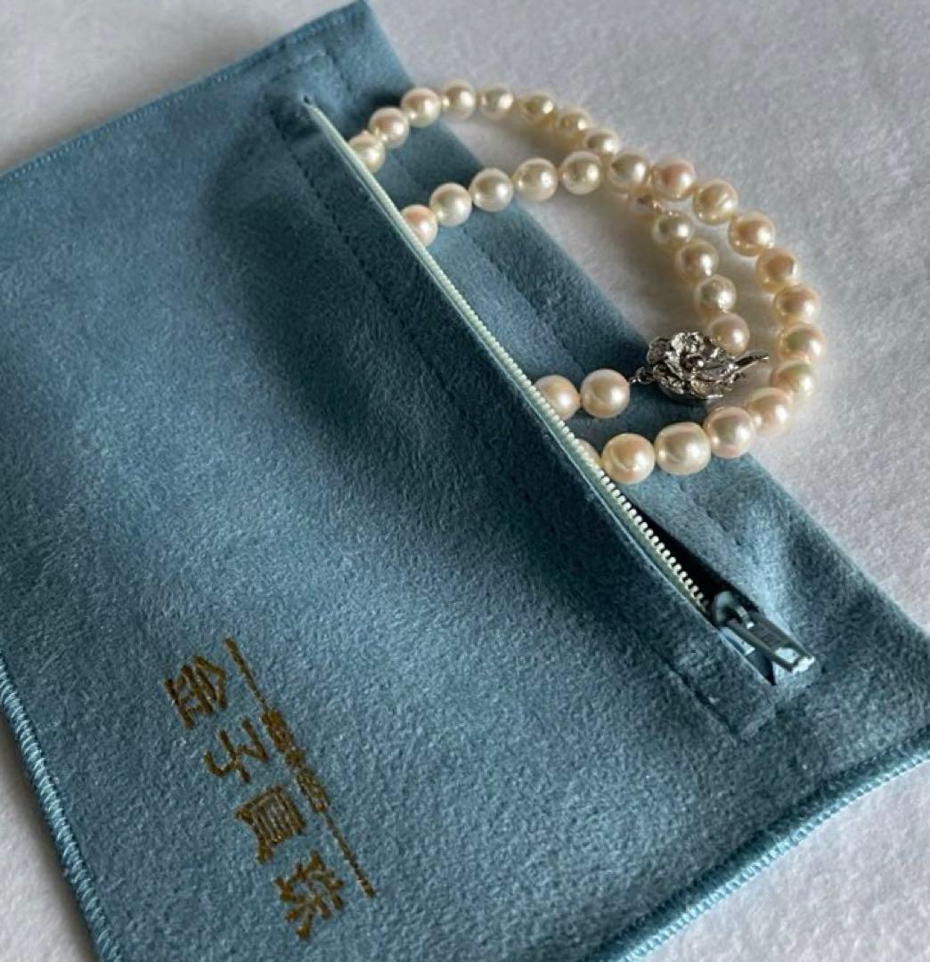 Natural 8mm Akoya pearl necklace with baroque pearls and silver clasp on a white background
