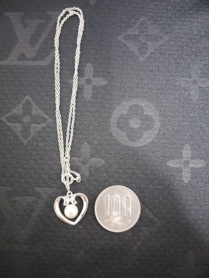 Mikimoto baby pearl necklace with heart-shaped silver pendant marked with M and SIL, length approximately 40cm