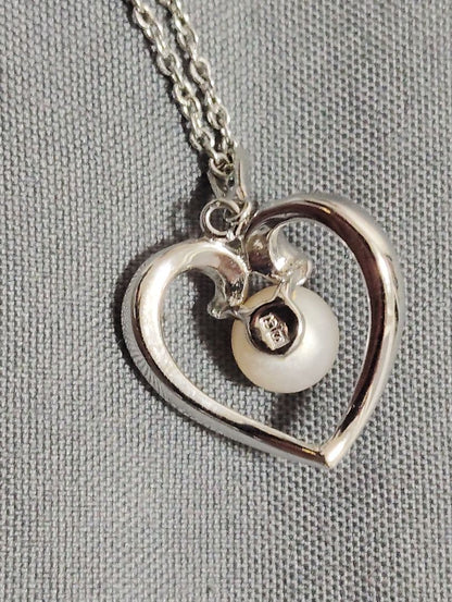 Mikimoto baby pearl necklace with heart-shaped silver pendant marked with M and SIL, length approximately 40cm