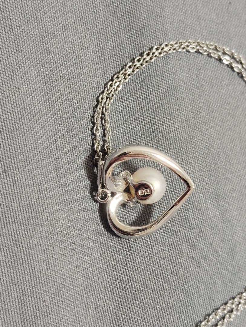 Mikimoto baby pearl necklace with heart-shaped silver pendant marked with M and SIL, length approximately 40cm