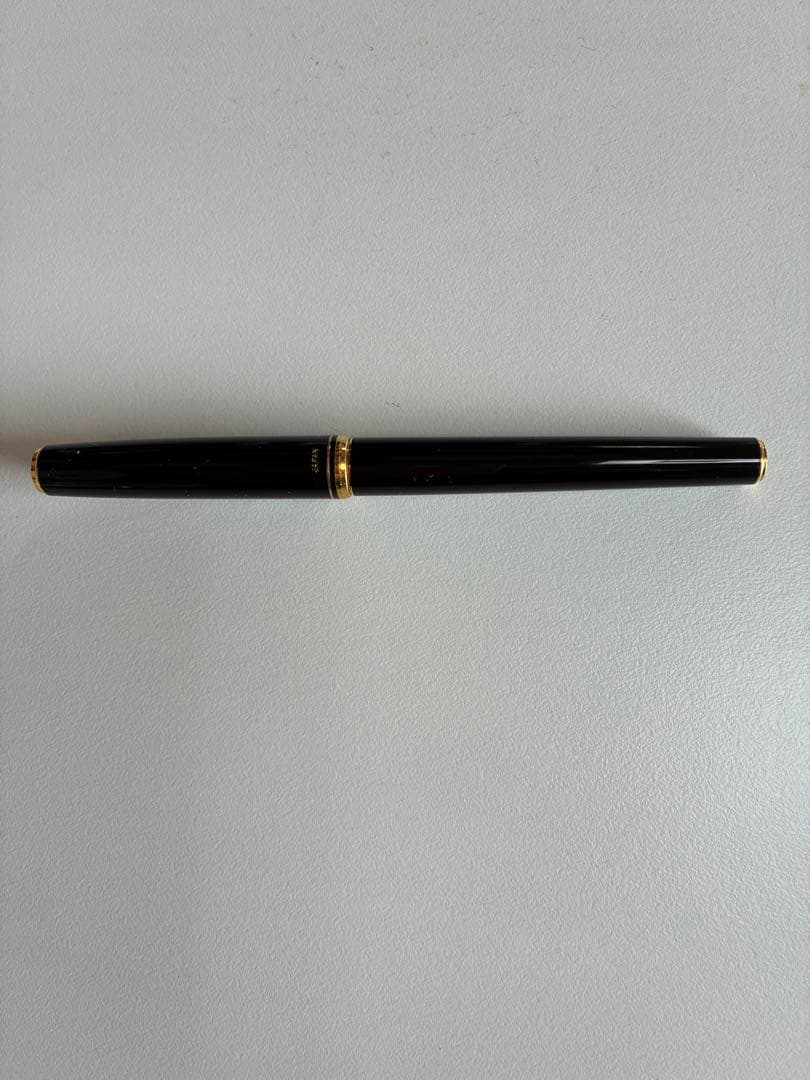 Pilot black fountain pen with medium gold-plated nib and included box, manual, and ink cartridges