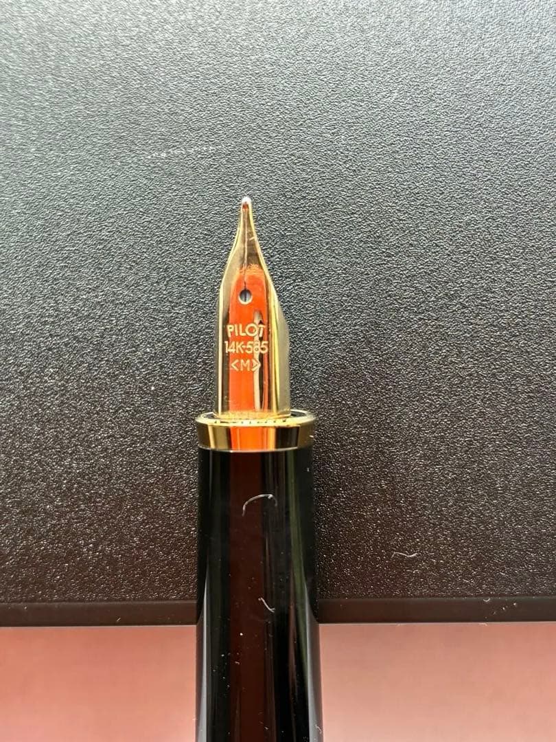 Pilot black fountain pen with medium gold-plated nib and included box, manual, and ink cartridges