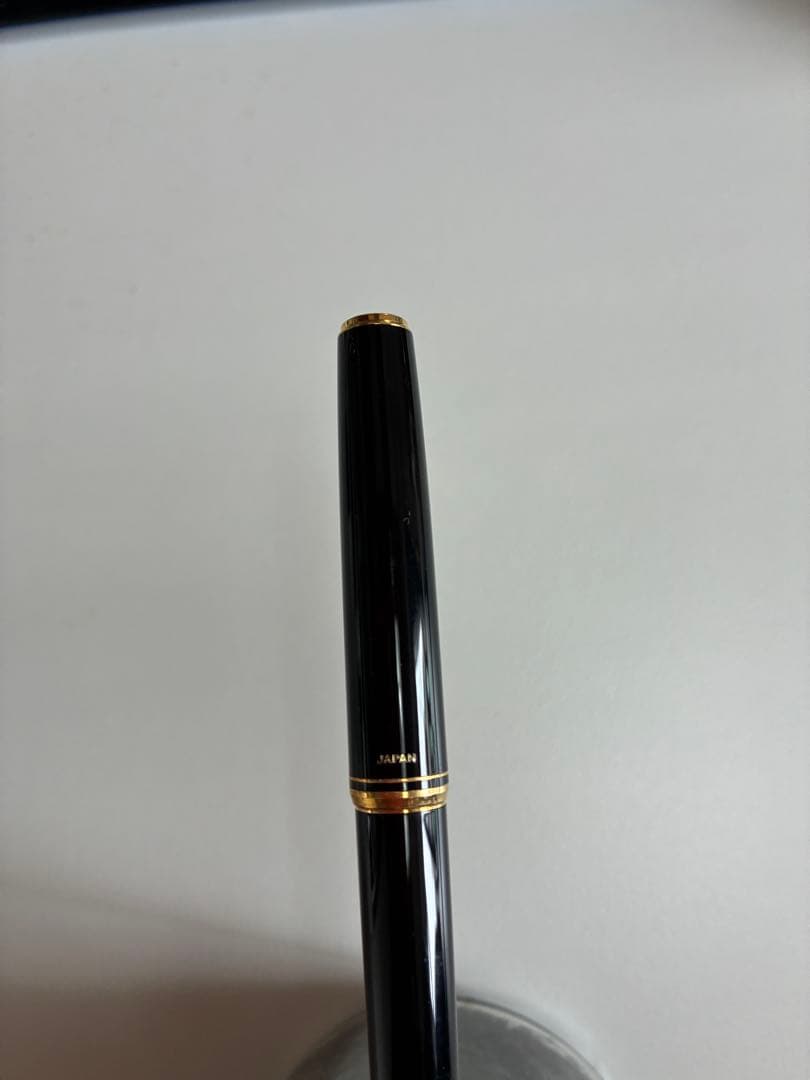 Pilot black fountain pen with medium gold-plated nib and included box, manual, and ink cartridges
