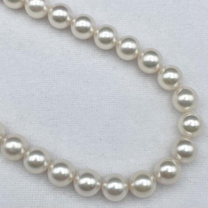 Akoya pearl necklace with 7-8mm pearls and silver clasp displayed on white background
