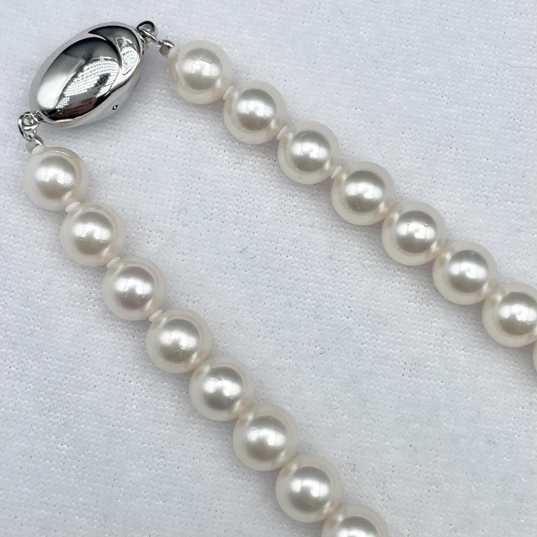 Akoya pearl necklace with 7-8mm pearls and silver clasp displayed on white background