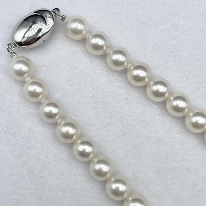 Akoya pearl necklace with 7-8mm pearls and silver clasp displayed on white background