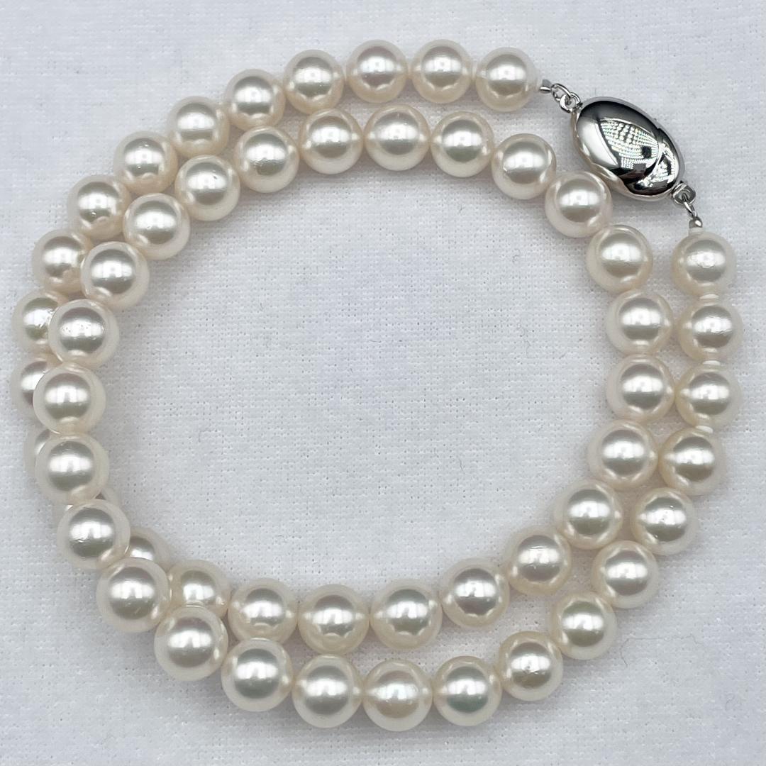 Akoya pearl necklace with 7-8mm pearls and silver clasp displayed on white background