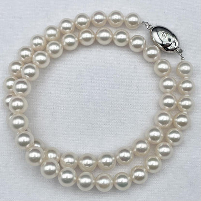Akoya pearl necklace with 7-8mm pearls and silver clasp displayed on white background