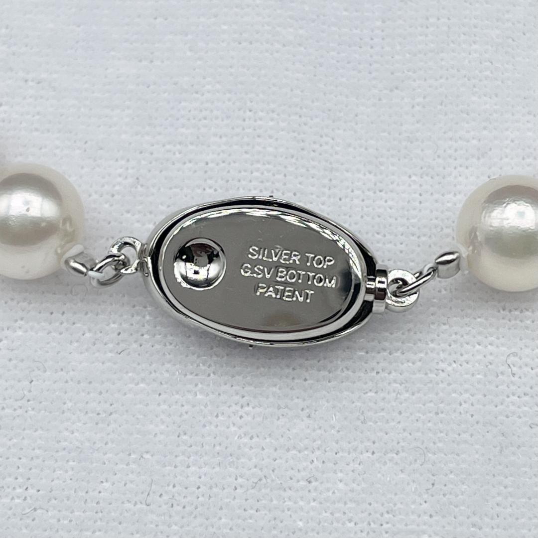 Akoya pearl necklace with 7-8mm pearls and silver clasp displayed on white background
