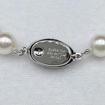 Akoya pearl necklace with 7-8mm pearls and silver clasp displayed on white background