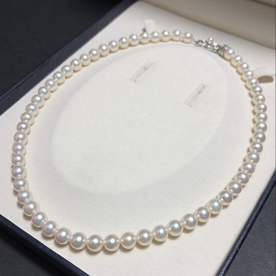 MIKIMOTO Akoya Pearl Necklace with 7.5 natural pearls and high luster on a white background