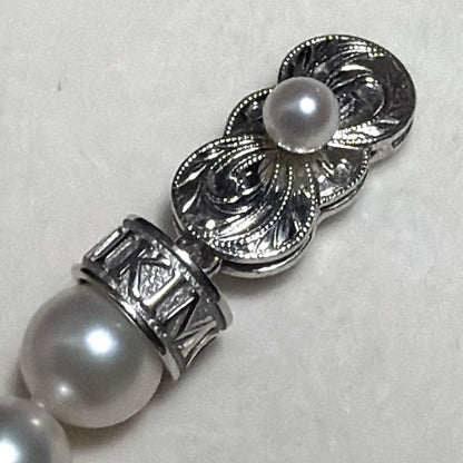 MIKIMOTO Akoya Pearl Necklace with 7.5 natural pearls and high luster on a white background