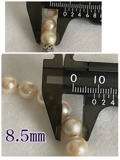 Aukoya pearl necklace with large 8.5mm round pearls and silver princess clasp on a white background