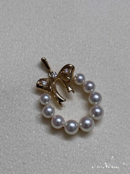 Mikimoto K18 gold pendant top shaped like a ribbon with pearl and diamond decorations