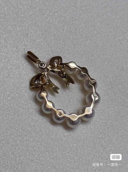 Mikimoto K18 gold pendant top shaped like a ribbon with pearl and diamond decorations