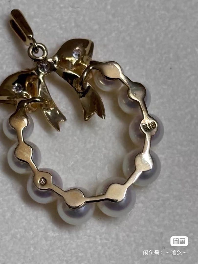 Mikimoto K18 gold pendant top shaped like a ribbon with pearl and diamond decorations