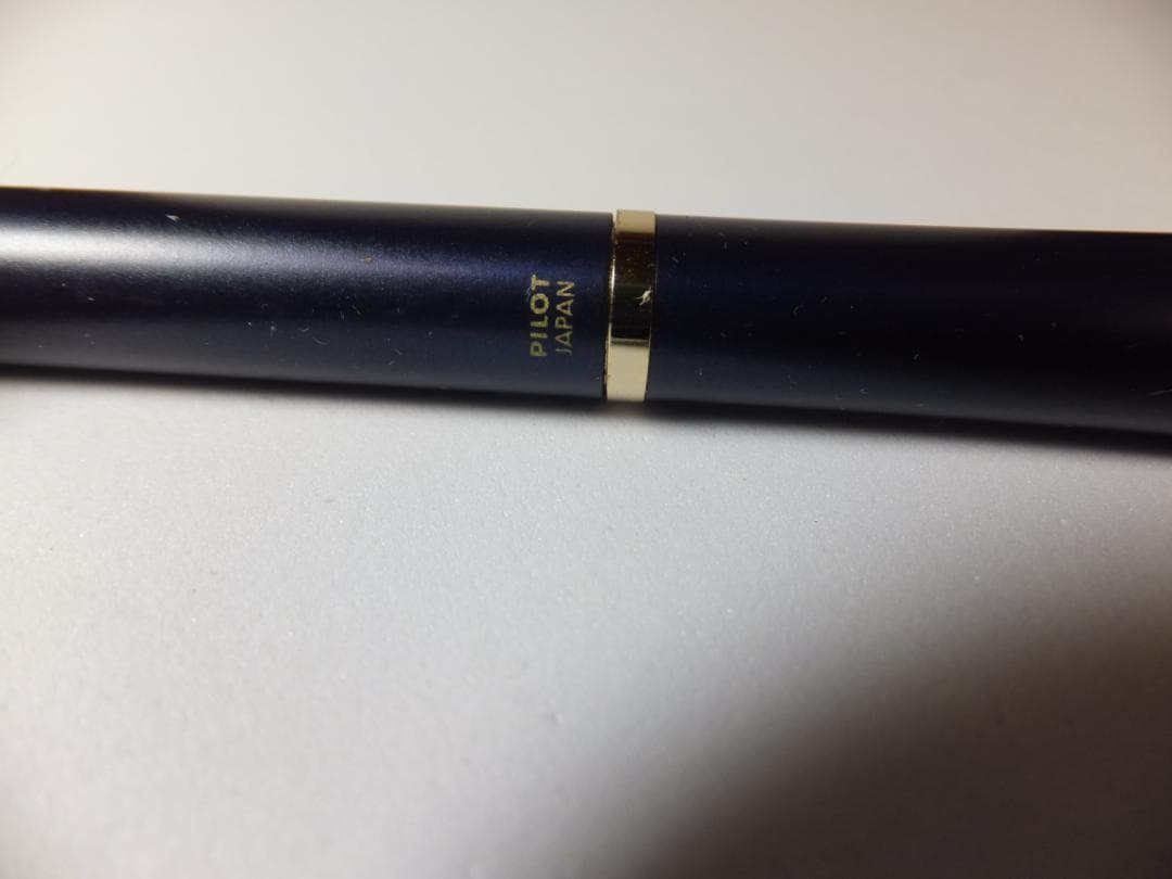 Used PILOT DRIVE ballpoint pen in navy color shown from side view