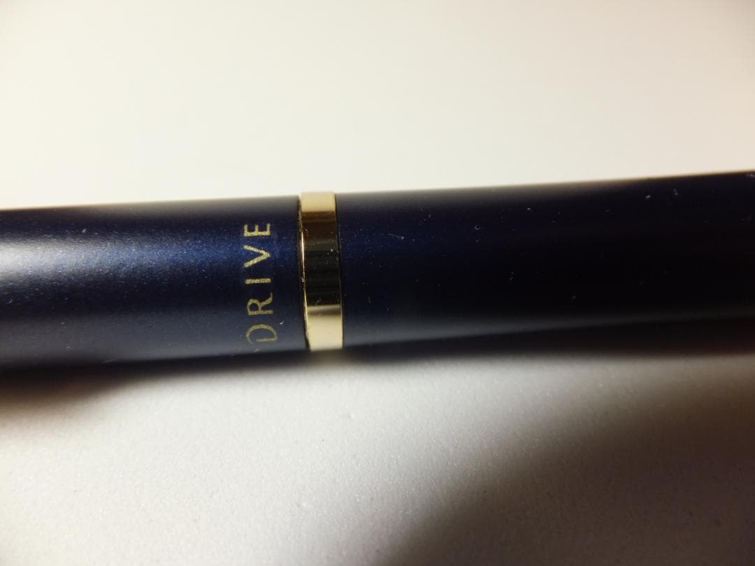 Used PILOT DRIVE ballpoint pen in navy color shown from side view